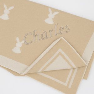 Close-up of embroidery on beige personalised baby blanket – Little Rabbits